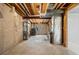 Unfinished basement features concrete walls, a small window, exposed beams, and mechanicals at 8603 Barberry Pl, Parker, CO 80134