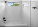 Bright bathroom with white subway tile, black fixtures, and a window above the tub at 8603 Barberry Pl, Parker, CO 80134