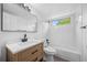 Bright bathroom featuring a new sink, toilet and shower/tub at 8603 Barberry Pl, Parker, CO 80134