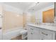 A well-lit bathroom featuring a vanity with marble countertop and a tub with shower at 8603 Barberry Pl, Parker, CO 80134
