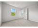 Bright bedroom features neutral carpet, two windows, and fresh paint at 8603 Barberry Pl, Parker, CO 80134