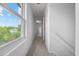 Bright upstairs hallway with natural light from large window and neutral carpet at 8603 Barberry Pl, Parker, CO 80134