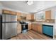 Bright kitchen with stainless steel refrigerator, wooden cabinets, and modern appliances at 8603 Barberry Pl, Parker, CO 80134
