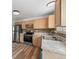 Efficient kitchen with stainless steel appliances, wood cabinets, and tile backsplash at 8603 Barberry Pl, Parker, CO 80134