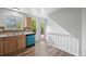 Bright kitchen featuring wood floors, stainless steel appliances, and a view to the backyard deck at 8603 Barberry Pl, Parker, CO 80134