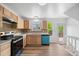 Kitchen featuring wood floors, stainless steel appliances, and a view to the backyard deck at 8603 Barberry Pl, Parker, CO 80134