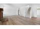 Open living room with hardwood floors, a fireplace, staircase and an adjacent kitchen at 8603 Barberry Pl, Parker, CO 80134