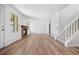 Inviting living room featuring hardwood floors, a fireplace, and staircase leading to the second floor at 8603 Barberry Pl, Parker, CO 80134