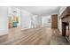 Spacious living room with hardwood floors, a cozy fireplace, and an open layout at 8603 Barberry Pl, Parker, CO 80134