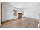 Bright living room with new flooring, a cozy brick fireplace, and lots of natural light at 8603 Barberry Pl, Parker, CO 80134