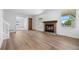 Bright living room with fireplace, hardwood floors, and access to other rooms in the home at 8603 Barberry Pl, Parker, CO 80134