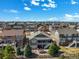 Aerial view of a charming two-story home with outdoor fireplace and well-maintained landscaping at 23713 E Eads Dr, Aurora, CO 80016