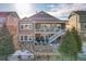 Multi-level backyard with a fire pit, patio furniture, and a charming stone retaining wall at 23713 E Eads Dr, Aurora, CO 80016