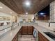 Stylish basement bar features rustic wood accents, brick details, and modern amenities at 23713 E Eads Dr, Aurora, CO 80016