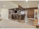 Finished basement bar area boasts rustic wood accents, brick details, and ample seating at 23713 E Eads Dr, Aurora, CO 80016