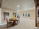 Spacious carpeted room features a round table with seating, brick accents, and recessed lighting at 23713 E Eads Dr, Aurora, CO 80016