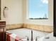 Bright bathroom features a soaking tub with tile surround and a large window offering an outdoor view at 23713 E Eads Dr, Aurora, CO 80016