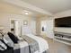 Bedroom featuring beige walls, an entertainment center, and ensuite bath at 23713 E Eads Dr, Aurora, CO 80016