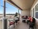 Inviting covered patio featuring wicker furniture and an outdoor lounge area at 23713 E Eads Dr, Aurora, CO 80016