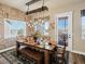 Inviting dining room features a rustic table with bench seating and a unique wooden beam light fixture at 23713 E Eads Dr, Aurora, CO 80016