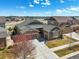 Beautiful home featuring stone accents, lush lawn, and a spacious driveway under a sunny sky at 23713 E Eads Dr, Aurora, CO 80016