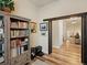 Hallway features hardwood floors, elegant lighting, and custom trim with an elegant staircase at 23713 E Eads Dr, Aurora, CO 80016