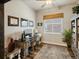 Well-lit home office with wooden desk, built-in shelving, and views from the window at 23713 E Eads Dr, Aurora, CO 80016