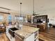 Open-concept kitchen with an island, dining area with outdoor access, flowing into a cozy living space at 23713 E Eads Dr, Aurora, CO 80016