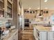 Modern kitchen with granite countertops, stainless appliances, brick backsplash, and convenient beverage area at 23713 E Eads Dr, Aurora, CO 80016