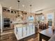 Gorgeous kitchen with brick backsplash, large island, stainless appliances, and adjacent dining area with outdoor views at 23713 E Eads Dr, Aurora, CO 80016