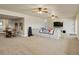 Large living room features a comfortable seating area, ceiling fans, and a TV at 23713 E Eads Dr, Aurora, CO 80016