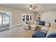 Spacious living room featuring neutral décor, large sectional, and sliding glass door to patio at 23713 E Eads Dr, Aurora, CO 80016
