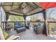 Inviting covered back porch with comfortable seating, string lights, and outdoor décor at 5316 S Rome St, Aurora, CO 80015
