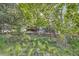 Scenic backyard view with lush greenery, a charming wooden fence, and natural landscaping at 5316 S Rome St, Aurora, CO 80015
