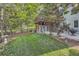 Lush backyard featuring a two-level deck, shed, mature trees, and a well-maintained lawn at 5316 S Rome St, Aurora, CO 80015