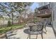 Backyard patio area featuring outdoor seating, a fire pit, and views of a lush backyard at 5316 S Rome St, Aurora, CO 80015