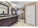 Elegant bathroom featuring a dual sink vanity, tiled shower, and neutral color scheme at 5316 S Rome St, Aurora, CO 80015
