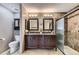 Elegant bathroom featuring a dual sink vanity, tiled shower, and neutral color scheme at 5316 S Rome St, Aurora, CO 80015