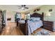 Bright bedroom with hardwood floors, a ceiling fan, and a large bed, creating a peaceful retreat at 5316 S Rome St, Aurora, CO 80015