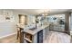 Open kitchen with a large island, stainless appliances, and hardwood flooring at 5316 S Rome St, Aurora, CO 80015