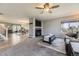 Inviting living room featuring a fireplace, ceiling fan, and large windows for lots of natural light at 5316 S Rome St, Aurora, CO 80015