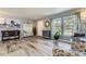 Bright and airy living room featuring wood floors, neutral walls, and large windows at 5316 S Rome St, Aurora, CO 80015