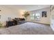 Bright living room featuring plush carpeting, large windows, and comfortable seating arrangement at 5316 S Rome St, Aurora, CO 80015