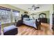 Spacious main bedroom with hardwood floors, a large bed, and natural light from the windows at 5316 S Rome St, Aurora, CO 80015