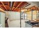 An unfinished basement space shows open ceiling with concrete and painted walls at 3685 W Union Ave, Denver, CO 80236