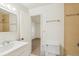 A well-lit bathroom shows a vanity with a sink, a toilet, and a tiled shower at 3685 W Union Ave, Denver, CO 80236