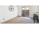 Dining area boasts carpeted floors and access to the fenced-in backyard via sliding glass doors at 3685 W Union Ave, Denver, CO 80236
