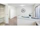 Bright dining area features neutral decor, a modern clock, and a built-in breakfast bar at 3685 W Union Ave, Denver, CO 80236
