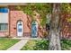 Charming brick townhomes feature well-manicured lawns and inviting entrances with bench for relaxing at 3685 W Union Ave, Denver, CO 80236