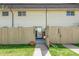 Exterior view of fenced backyards and sliding glass door entry on a sunny day at 3685 W Union Ave, Denver, CO 80236